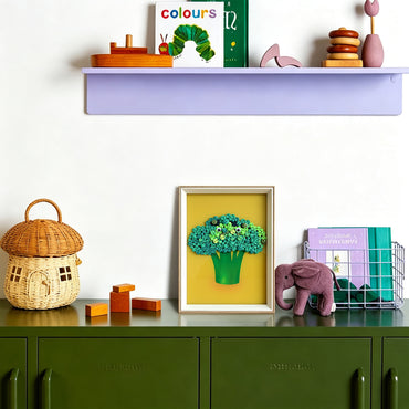 Broccoli button art displayed as colorful wall decor in a cozy living room