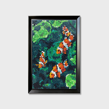 Coral Harmony button art featuring four clownfish swimming in a vibrant green pond
