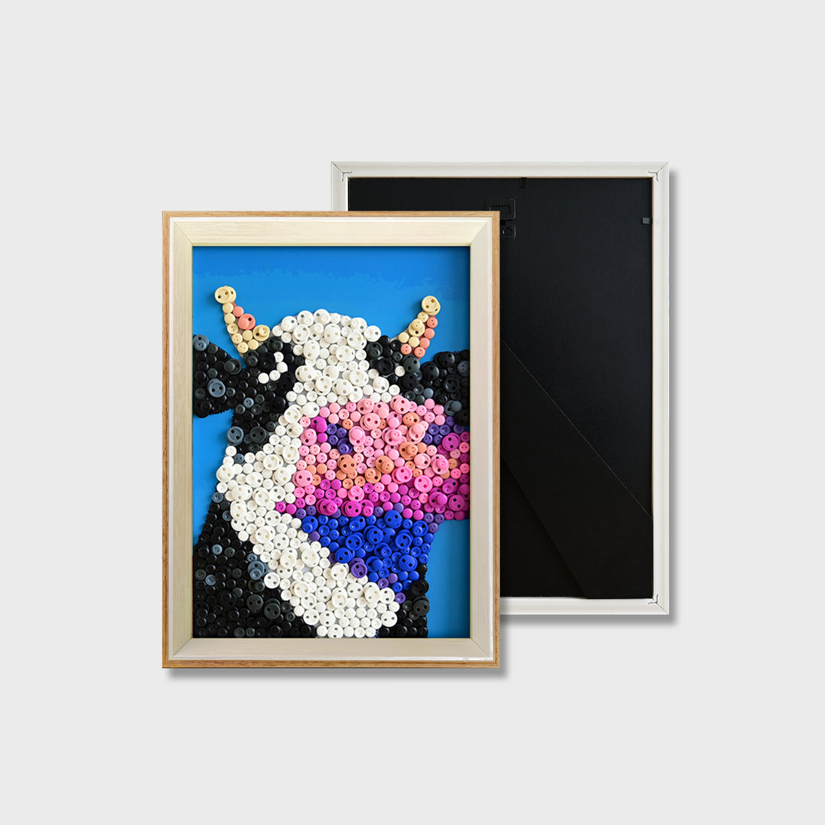 Finished Cow button art featuring a cute black and white cow design
