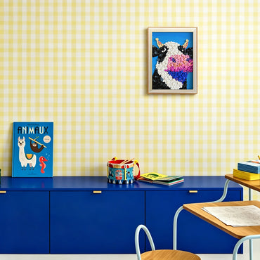 Cow button art displayed as playful wall decor in a cozy living room