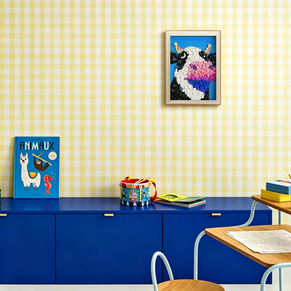 Cow button art displayed as playful wall decor in a cozy living room