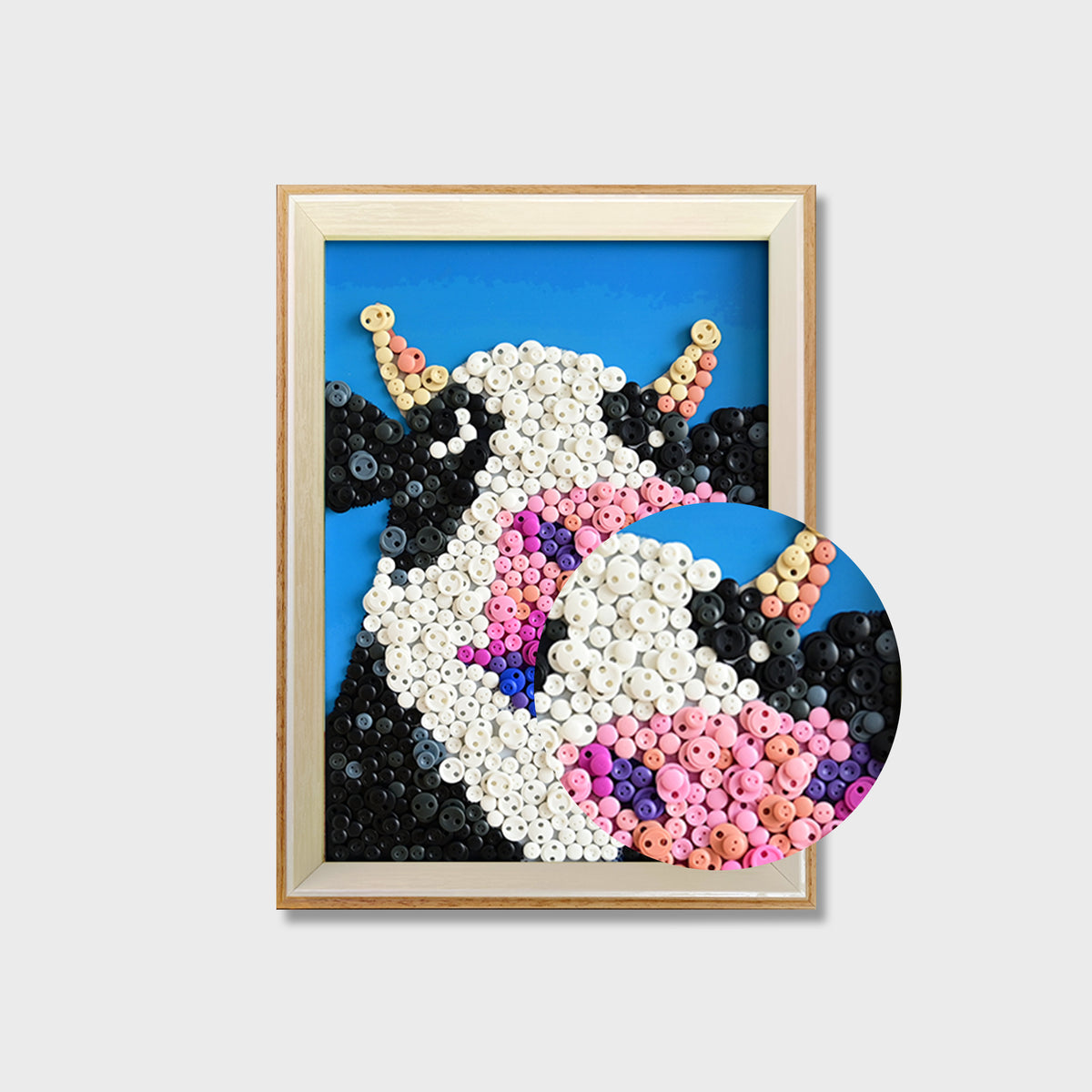 Close-up of Cow button art showing colorful buttons and detailed textured cow features