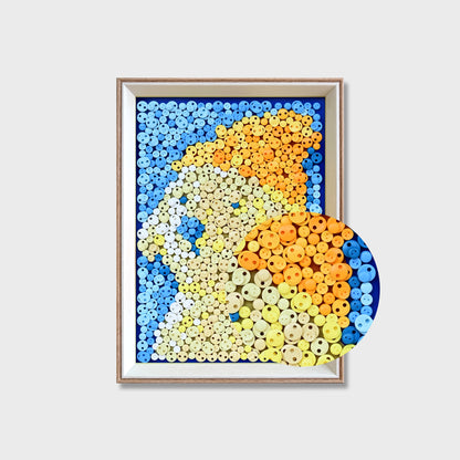 Close-up of Creamy Puppy button art showing yellow-toned buttons forming the puppy against a pale blue textured background