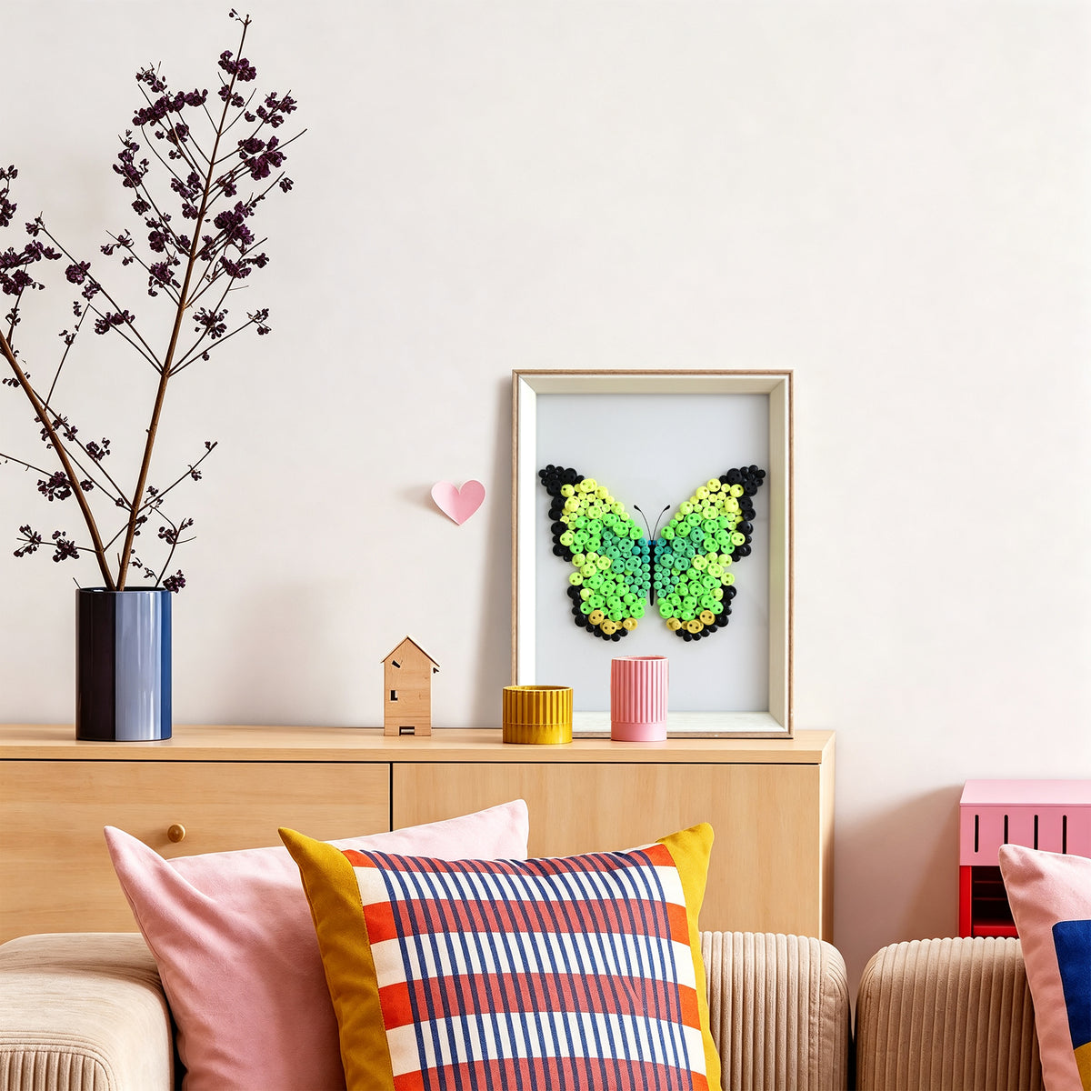 Green Butterfly button art displayed as colorful wall decor in a cozy living room
