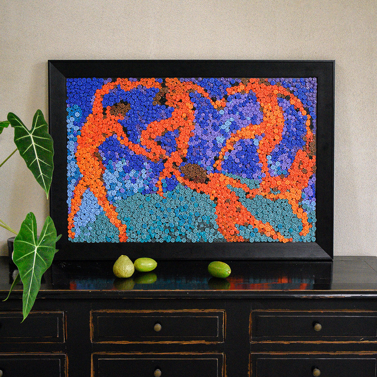 The La Danse button art displayed as expressive wall decor in a cozy living room