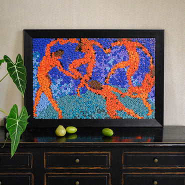 The La Danse button art displayed as expressive wall decor in a cozy living room