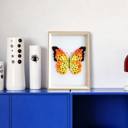 Orange Butterfly button art displayed as colorful wall decor in a cozy living room