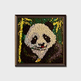 Panda button art featuring a cute panda resting beside bamboo in a natural scene