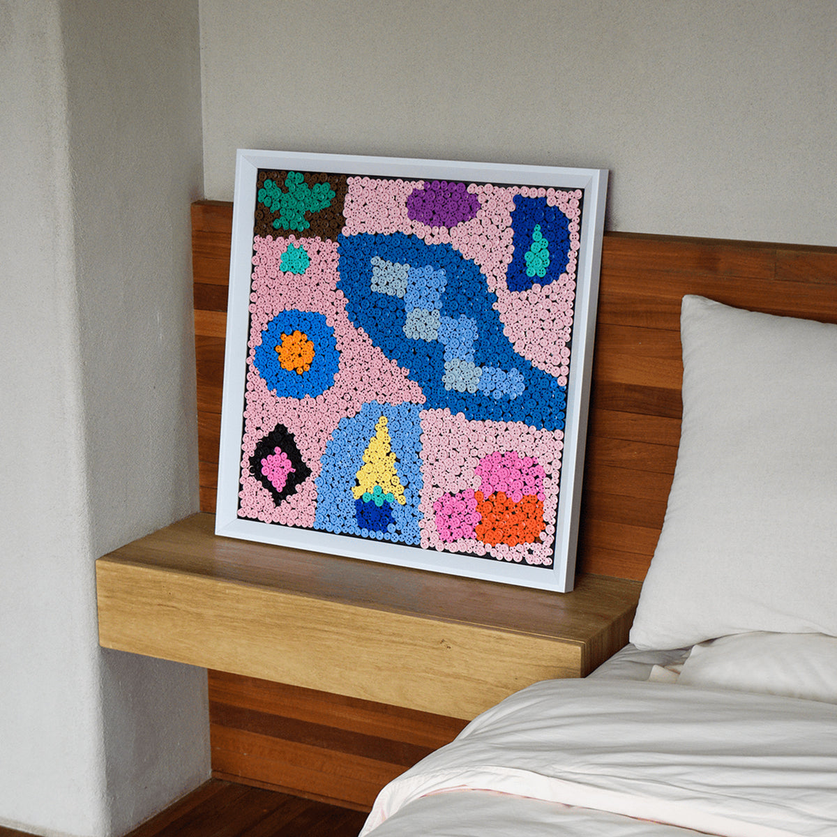 Pastel Party button art displayed as statement abstract wall decor in a modern interior