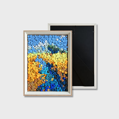 Finished River button art featuring a blue river winding through golden wheat fields under a blue sky