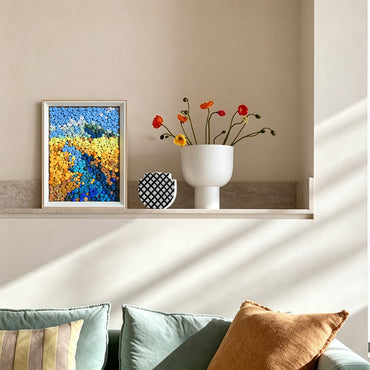 River button art displayed as landscape wall decor in a cozy living room