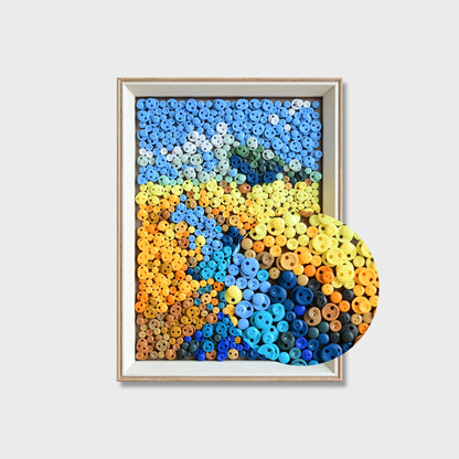 Close-up of River button art showing blue buttons forming a flowing river through golden wheat fields beneath a textured blue sky