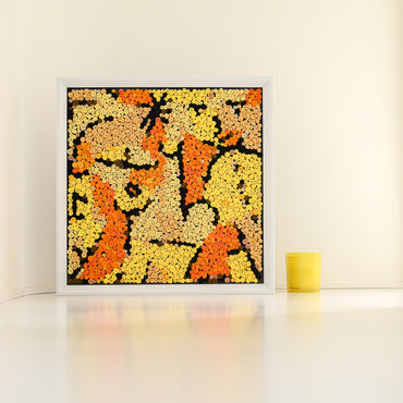 The Signes en Jaune button art displayed as contemporary wall decor in a cozy living room
