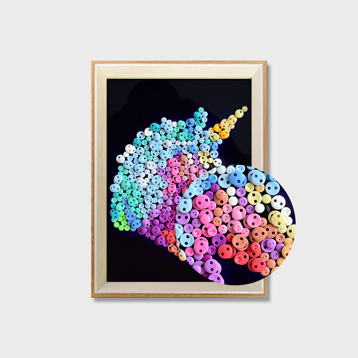 Close-up of Unicorn button art showing colorful buttons and a blue and white textured mane on a black background