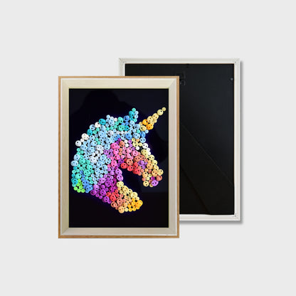 Finished Unicorn button art featuring a colorful unicorn with a blue and white mane on a black background
